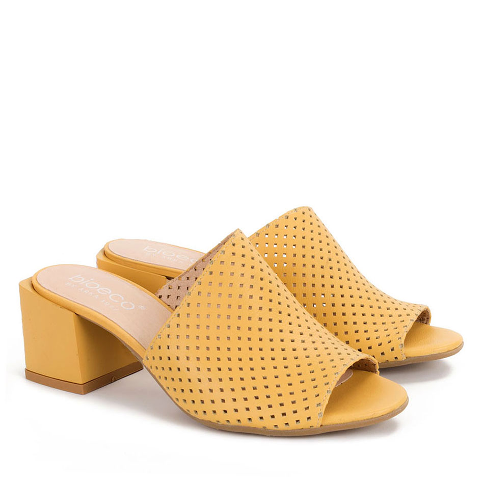  Yellow perforated slippers with a decorative heel