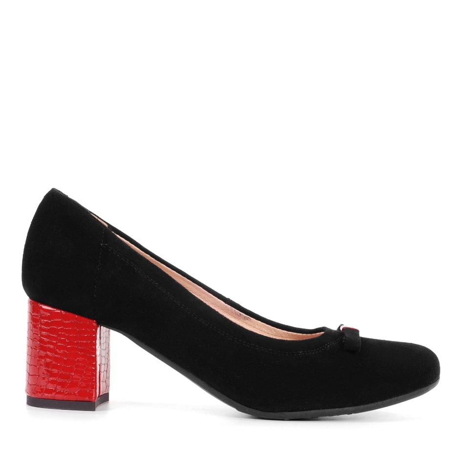 Black velor pumps with a red heel