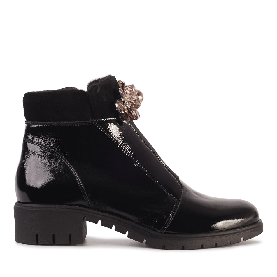 Black leather ankle boots with an ornament